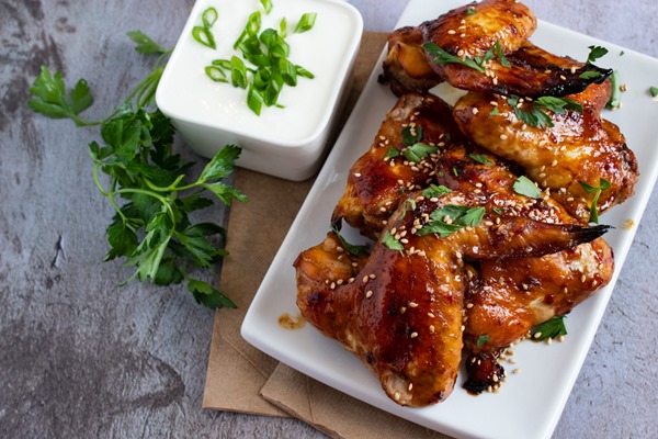 molasses chicken wings on a white plate