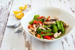 bowl of salad with red peppers and oranges