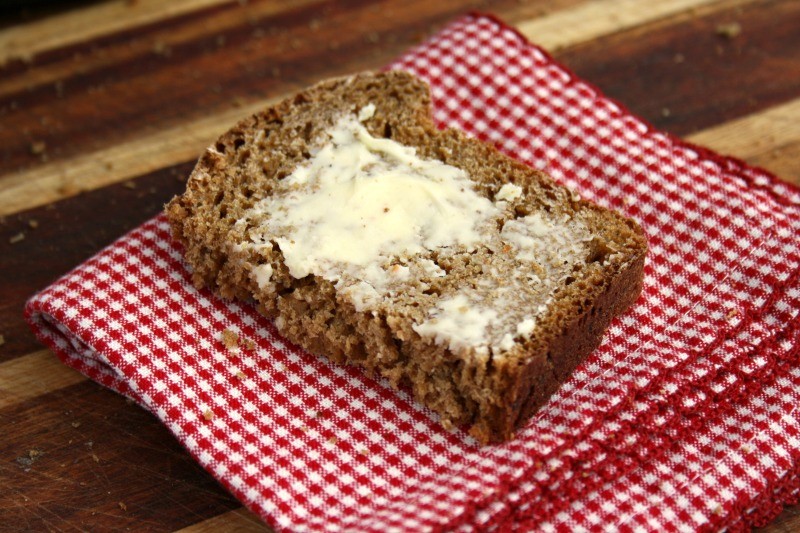 Molasses Brown Bread on red cloth with butter