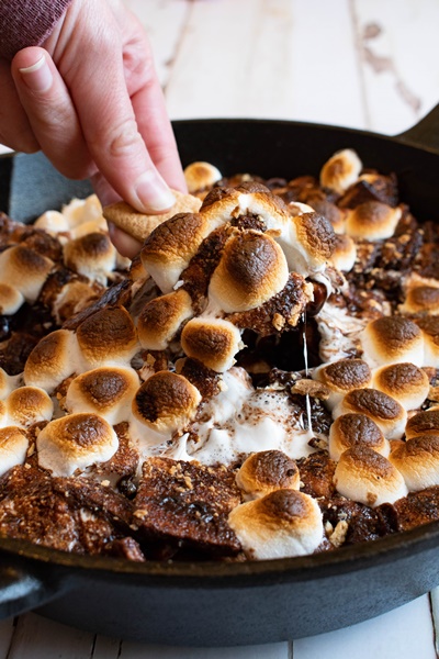 smores in a pan with hand