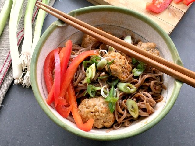 Korean turkey meatballs are highly seasoned with fresh ginger, garlic, sesame oil and a little molasses. Once cooked they're tossed with simply spiced noodles that are seasoned with gochujang. 
