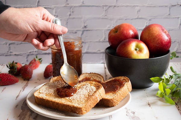 Strawberry and Rhubarb Jam on toast and hands