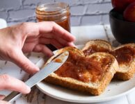 Strawberry and Rhubarb Jam with hands