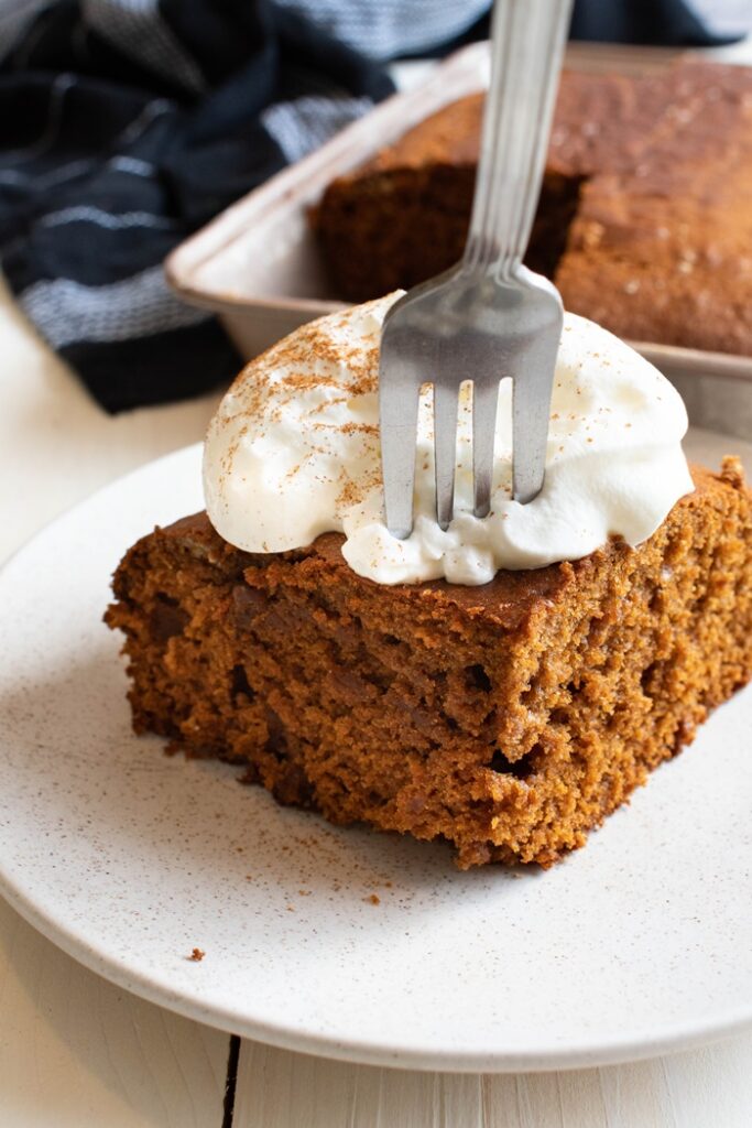 olive oil cake with whipped cream and fork