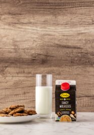 Crosby's Fancy Molasses with a glass of white milk and molasses cookies
